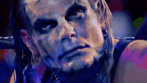a close up of a wrestler 's face with a lot of makeup on it .
