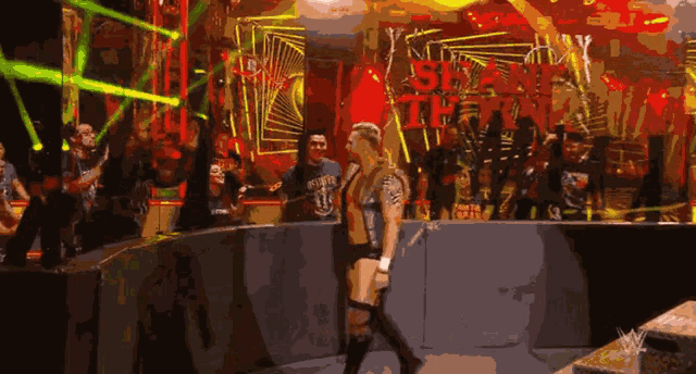 a woman in a wrestling ring with a sign that says six feet tall
