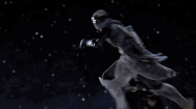 a man with a beard is holding a lightsaber in his hand