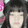 a blurry picture of a woman 's face with her eyes closed and a pink background .