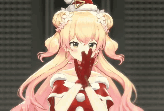 a girl wearing a santa hat and red gloves