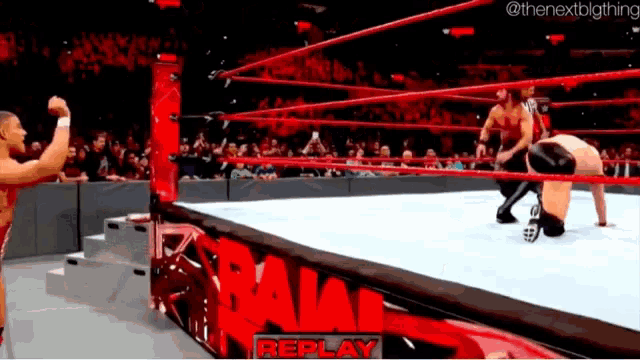two wrestlers in a wrestling ring with the word replay on the side
