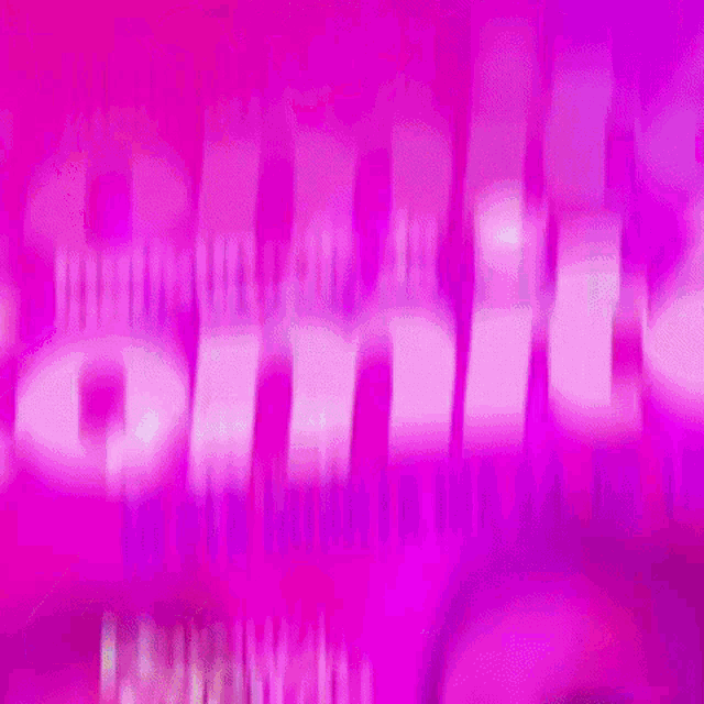 a blurry picture of two people standing next to each other in front of a purple background .