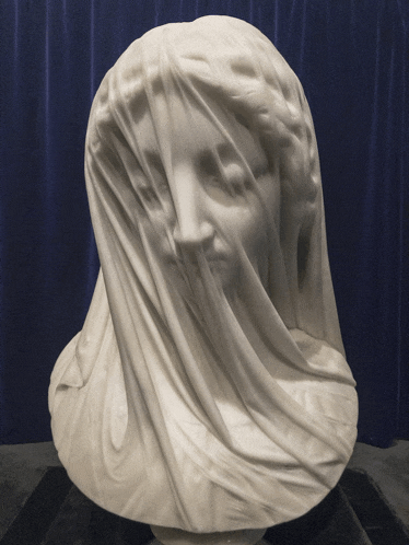 a statue of a woman with a veil draped over her face