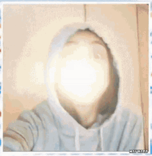 a woman is wearing a hoodie and making a funny face .