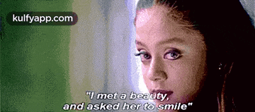 a close up of a woman 's face with the words `` i met a beauty and asked her to smile ''
