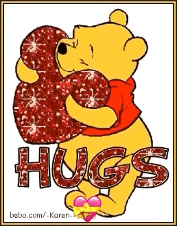 a picture of winnie the pooh holding a heart with the words hugs written on it