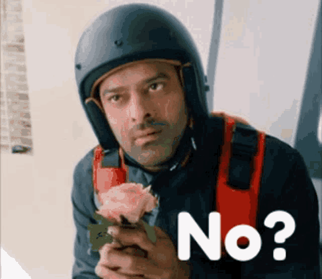 a man wearing a helmet is holding a rose and the word no is on the bottom .