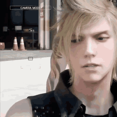 a close up of a man 's face with a camera mode displayed above him