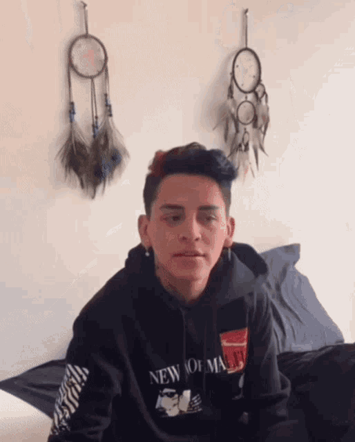a young man wearing a hoodie that says new york on it