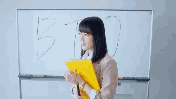 a woman stands in front of a white board with the words no comment written on it