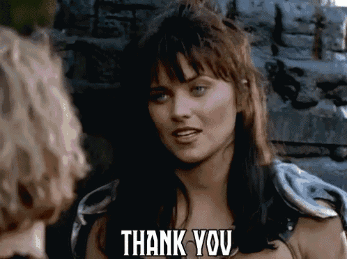a woman says thank you to another woman in front of a stone wall