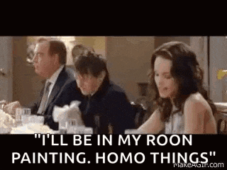 a man and a woman are sitting at a table with a man in a suit .