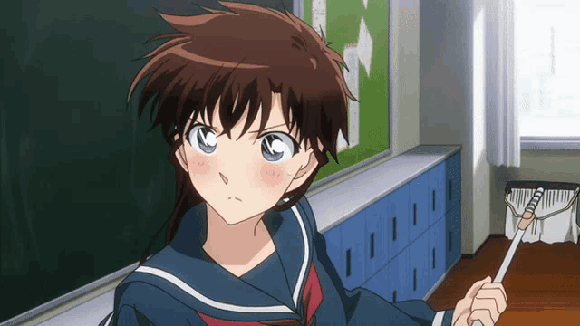 a girl in a sailor suit is holding a broom