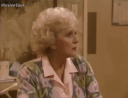 a woman in a floral shirt is sitting in front of a wall with illusive soul written below her
