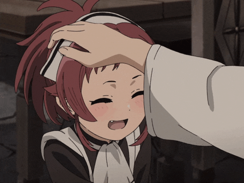 a girl with red hair is being patted on the head by a person in a white shirt