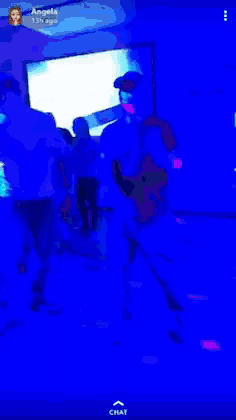 a group of people are dancing in front of a screen that says chat