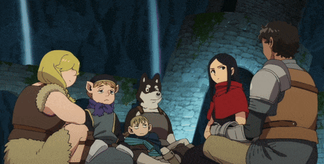 a group of people are sitting in a circle and one of them is wearing a red hood