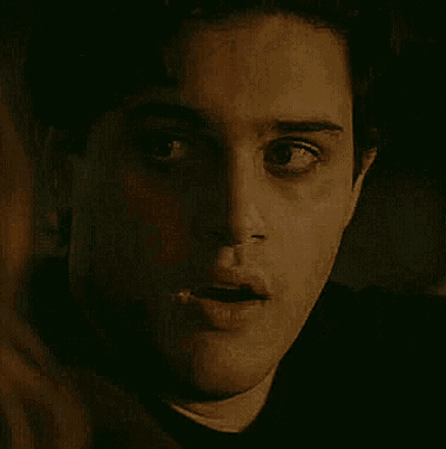 a close up of a man 's face in the dark .