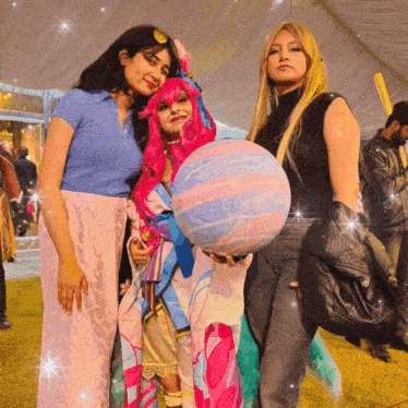 a woman in a pink wig is holding a rainbow ball