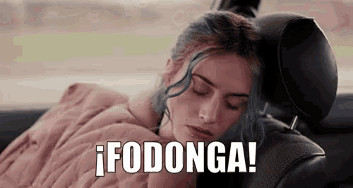 a woman is sleeping in the back seat of a car with the words `` fodonga '' written above her .