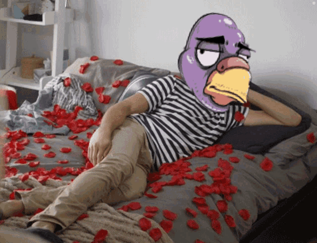 a man laying on a bed with a purple bird head on his head
