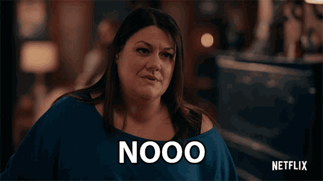 a woman in a blue shirt has the word nooo on her shirt