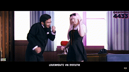 a man and a woman are dancing in front of a screen that says loucamente vou discutir