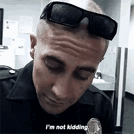 a police officer wearing sunglasses says i 'm not kidding