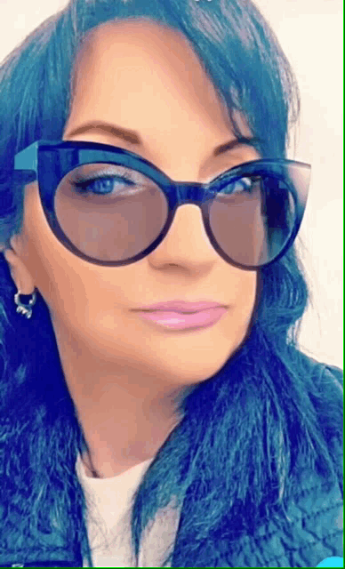 a woman with blue hair is wearing a pair of sunglasses