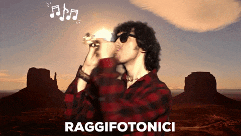 a man in a plaid shirt is singing into a microphone with the words raggifotonici written on the bottom