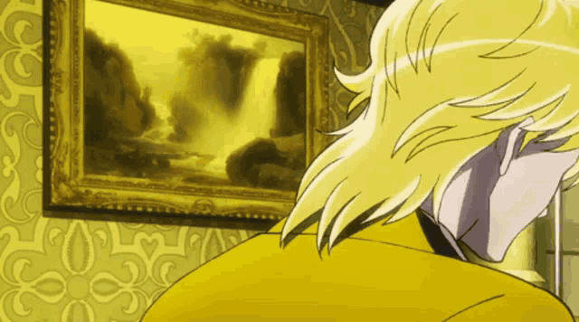 a man in a yellow jacket looks at a painting on a wall