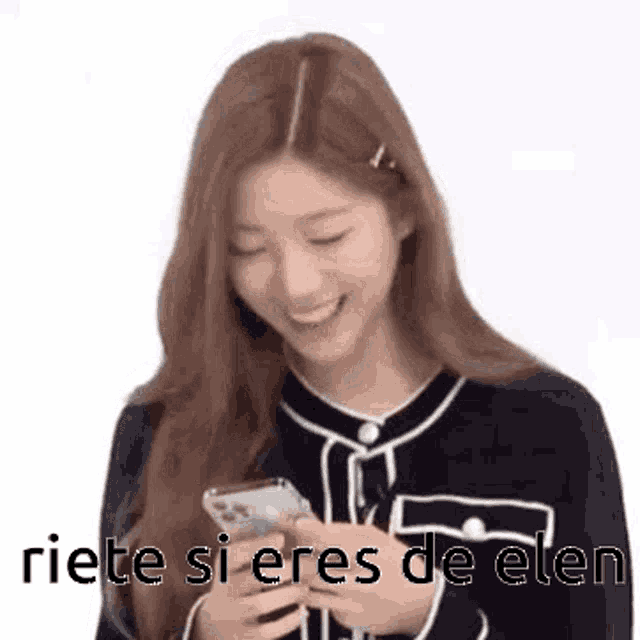 a woman is smiling while holding a cell phone in her hands .