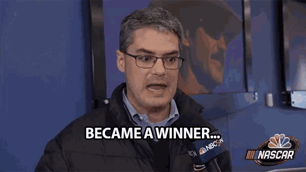 a man with glasses says became a winner in front of a nascar logo