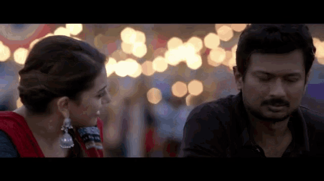 a man and a woman are looking at each other in a blurry photo