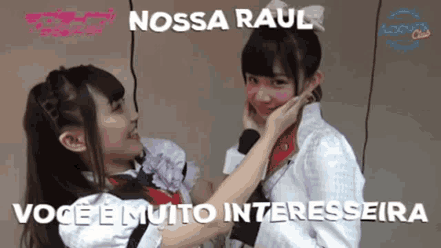 two girls are touching each other 's face and the caption says nossa raul voce e muito interessante