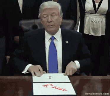 donald trump is sitting at a desk with a drawing of a hand on a piece of paper that says usad