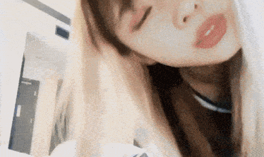 a close up of a woman 's face with her eyes closed and her mouth open
