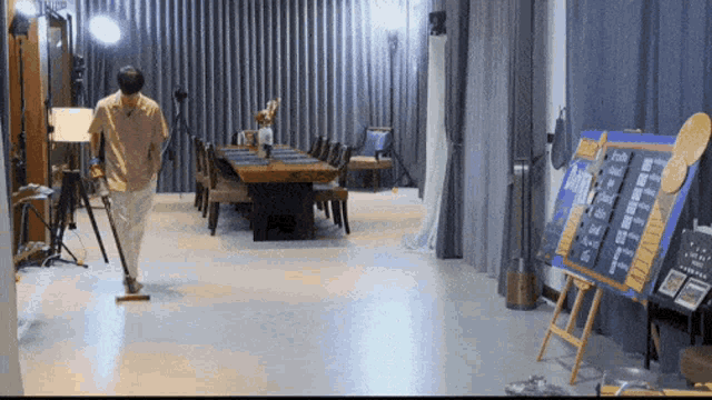a man is cleaning the floor of a room with a sign that says ' a ' on it