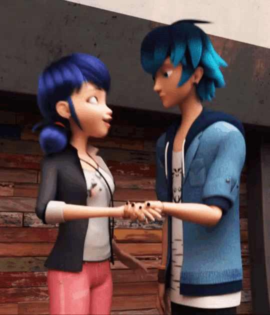 a boy and a girl are standing next to each other and holding hands