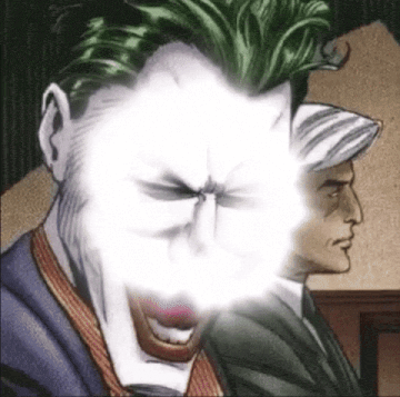 a close up of the joker 's face with a light coming out of it .