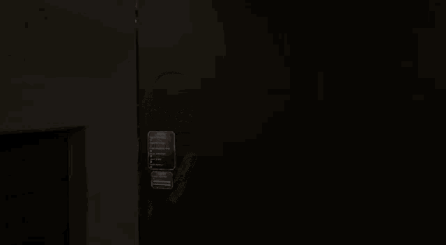 a man with glasses is peeking out from behind a wall