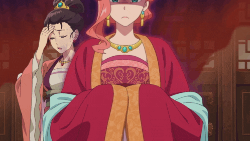 a woman in a red dress holds her head while standing next to another woman