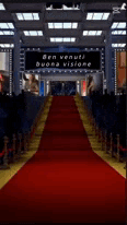 a red carpet leading to a sign that says ben venuti buona visione .