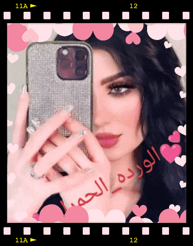 a woman is taking a picture of herself with a cell phone with hearts around her