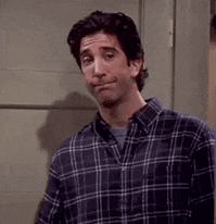 a man in a plaid shirt is making a funny face .