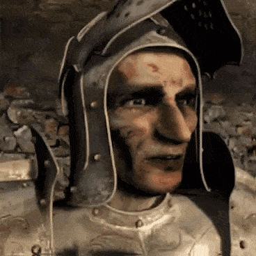 a man in armor with a helmet on his head is looking at the camera .