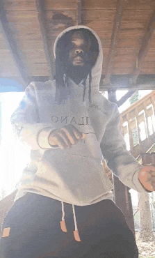 a man wearing a hoodie with the word omaji on it