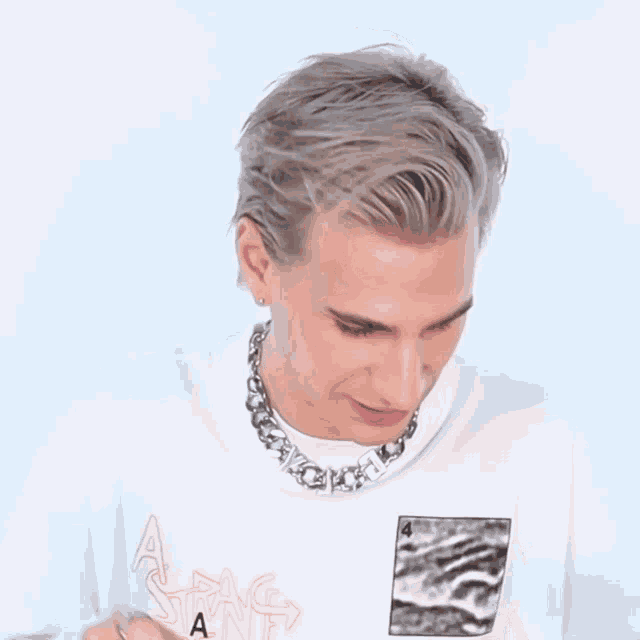 a man wearing a necklace and a white shirt says you 're a great guy
