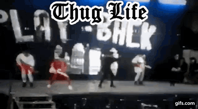 a group of people are dancing on a stage with the words thug life play back in the background .
